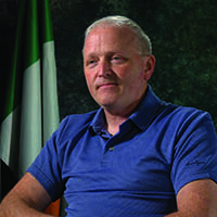 A photo of man in a blue shirt.